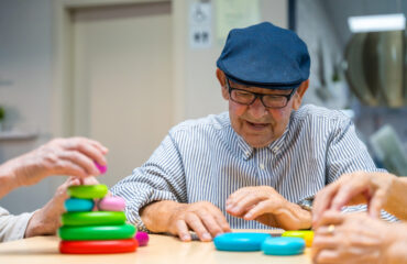 Elder man playing skill games in a nursing home Elder man playing skill games in a nursing home