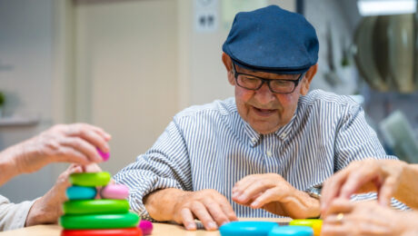 Elder man playing skill games in a nursing home Elder man playing skill games in a nursing home